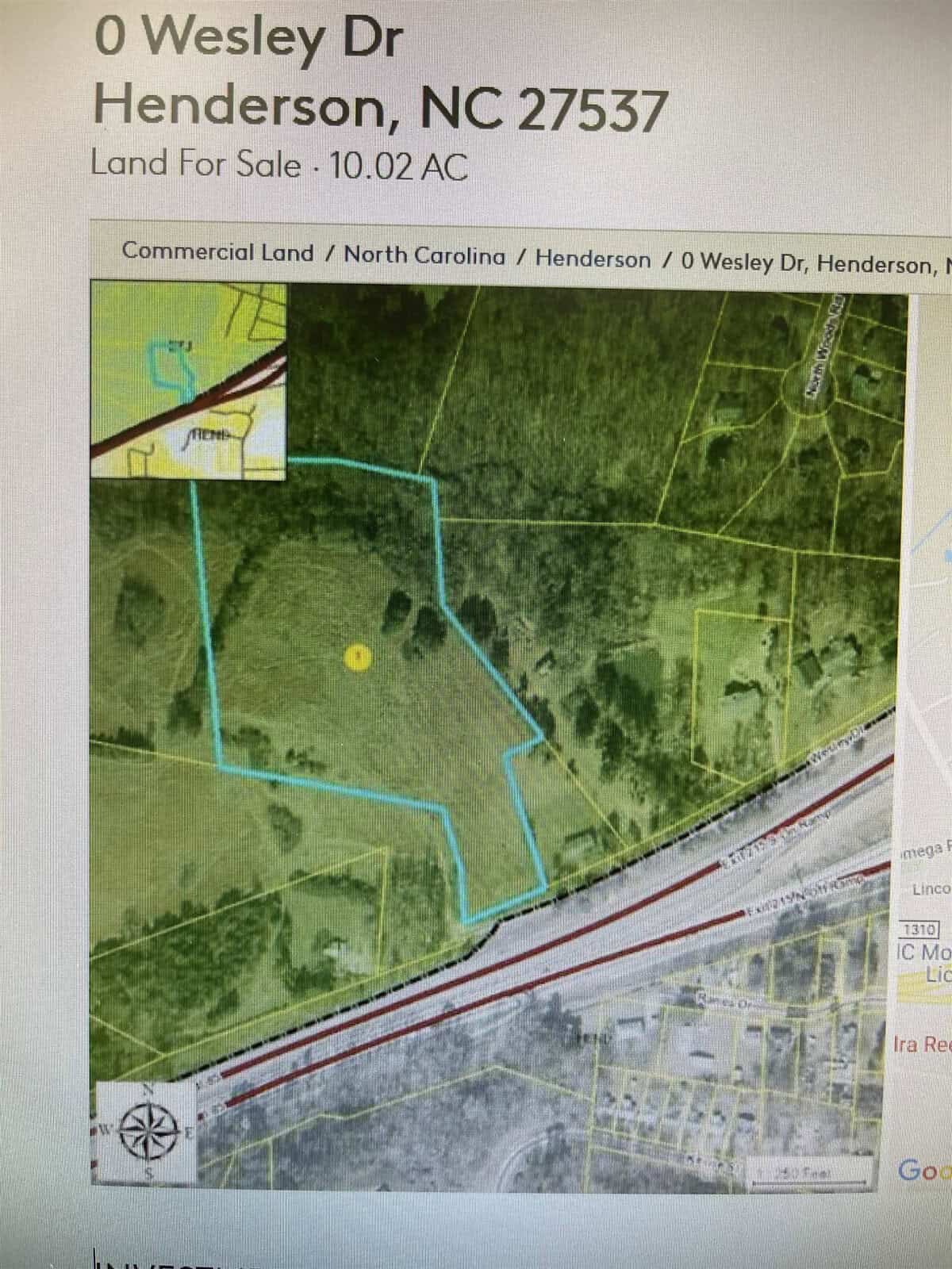 Satellite view of a parcel of commercial land for sale, outlined in blue, located near wesley dr, henderson, nc 27537, with surrounding roads and terrain visible.