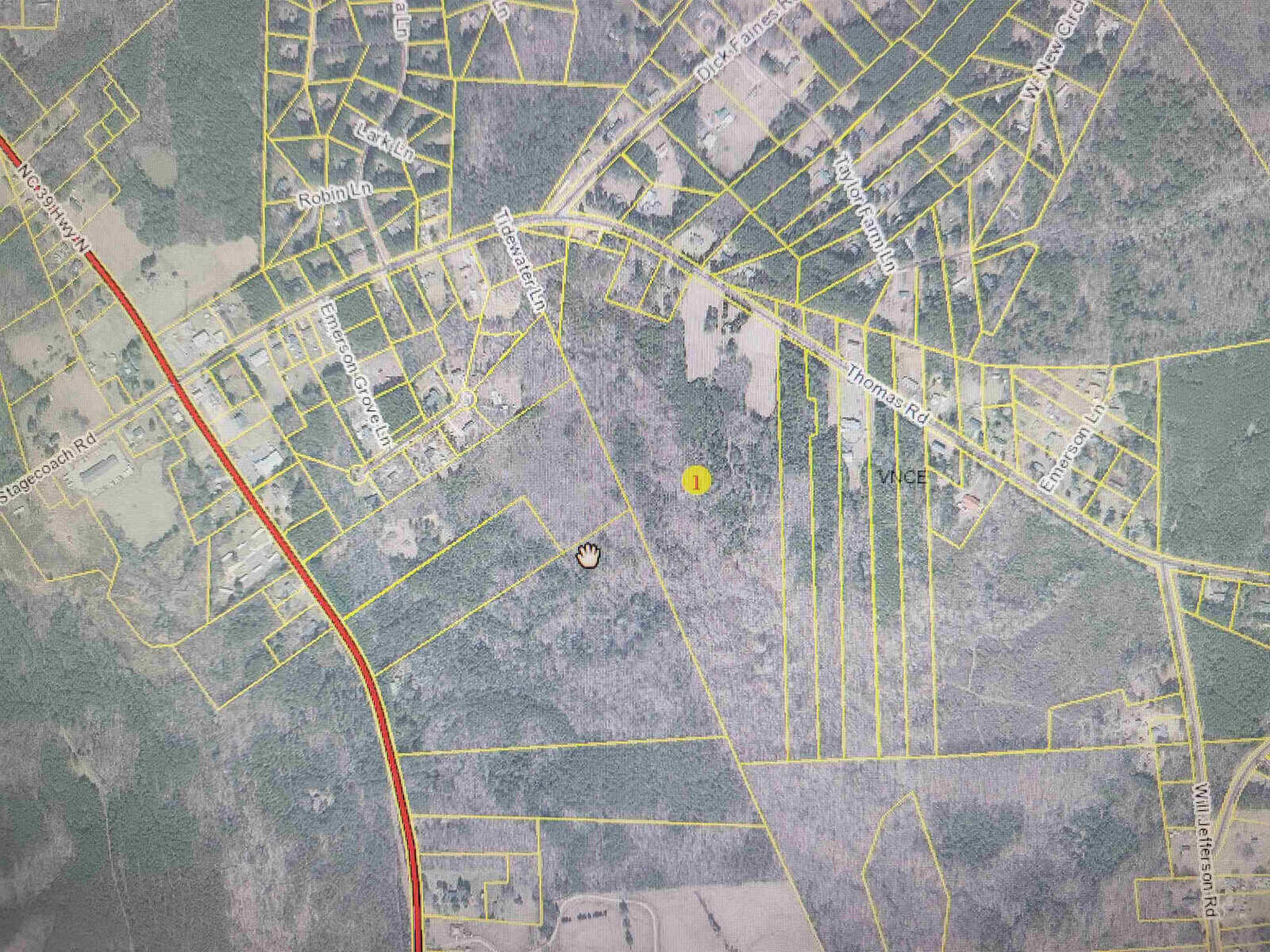 Map view of a residential area with streets and property boundaries, featuring a yellow marker indicating a specific location.