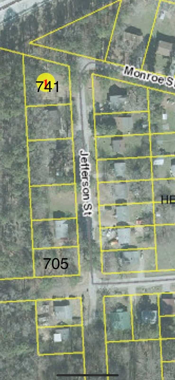 An aerial view of a residential area showing a grid layout with marked parcels, streets named monroe st. and jefferson st., and house numbers 741 and 705 visible.