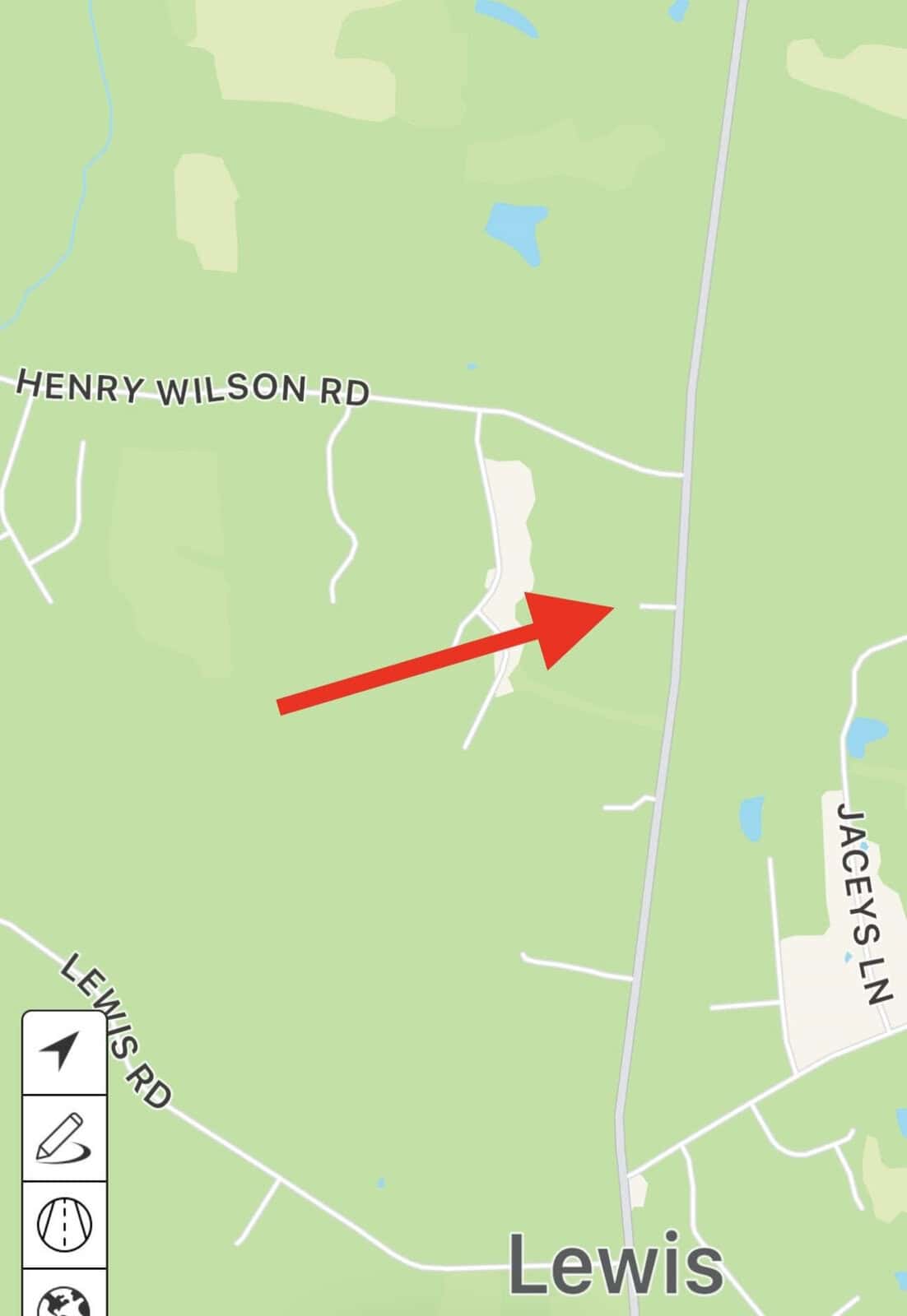Map showing a highlighted route with a red arrow pointing towards an area near Henry Wilson Rd, Jaceys Ln, and Lewis Rd in Lewis. Green landscape background with white road lines. Compass and map tools are visible at the bottom left.
