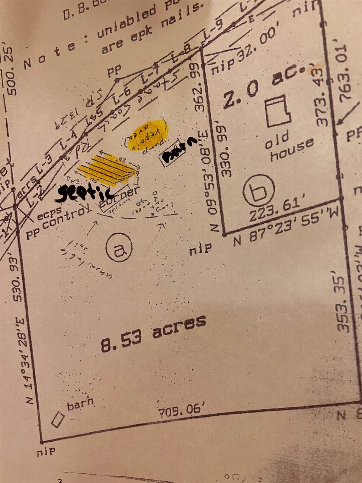 An old survey map showing property boundaries. Highlighted areas include a "septic" area and a "well". Notations indicate features such as a "barn" and "old house" within 8.53 acres. Various measurements and coordinates are visible.
