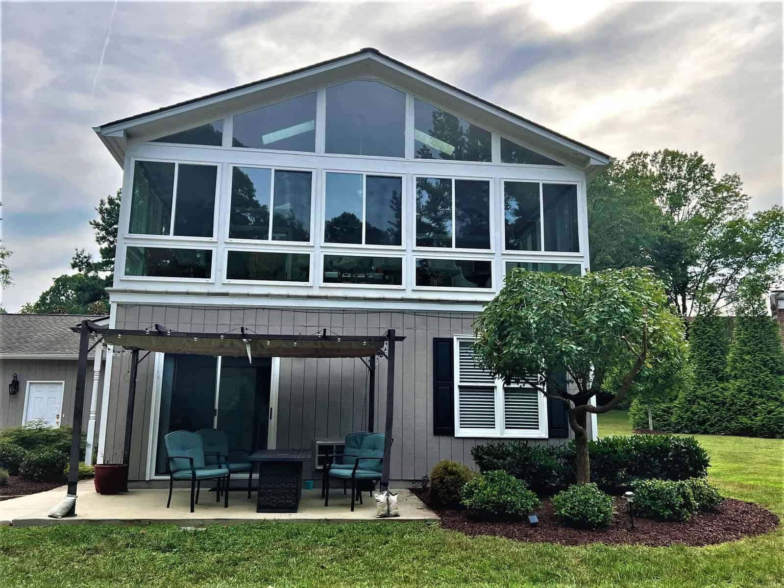 A house in Henderson NC with a patio and a tree, located at 301 Pebble Hill Lane.