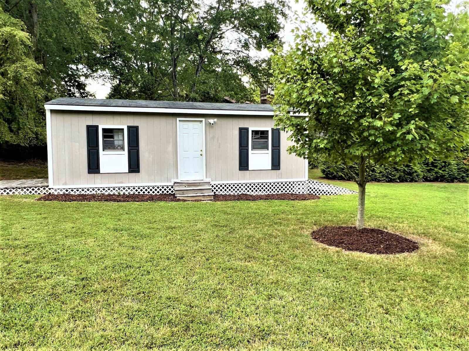 A small tree in a yard located at 301 Pebble Hill Lane in Henderson, NC.