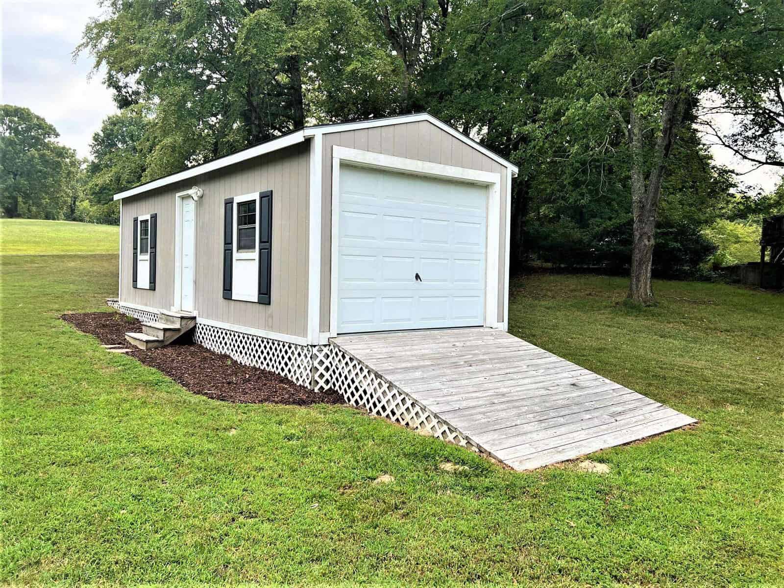 A house with a ramp in the grass located at 301 Pebble Hill Lane in Henderson, NC.