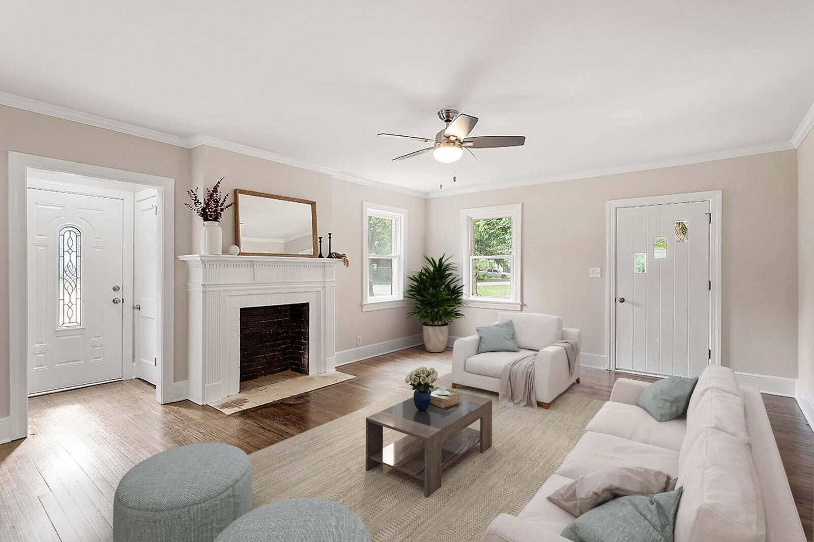 A well-lit living room with neutral colors featuring a fireplace, ceiling fan, and various seating arrangements, including sofas and chairs, with a hardwood floor and white entrance doors.