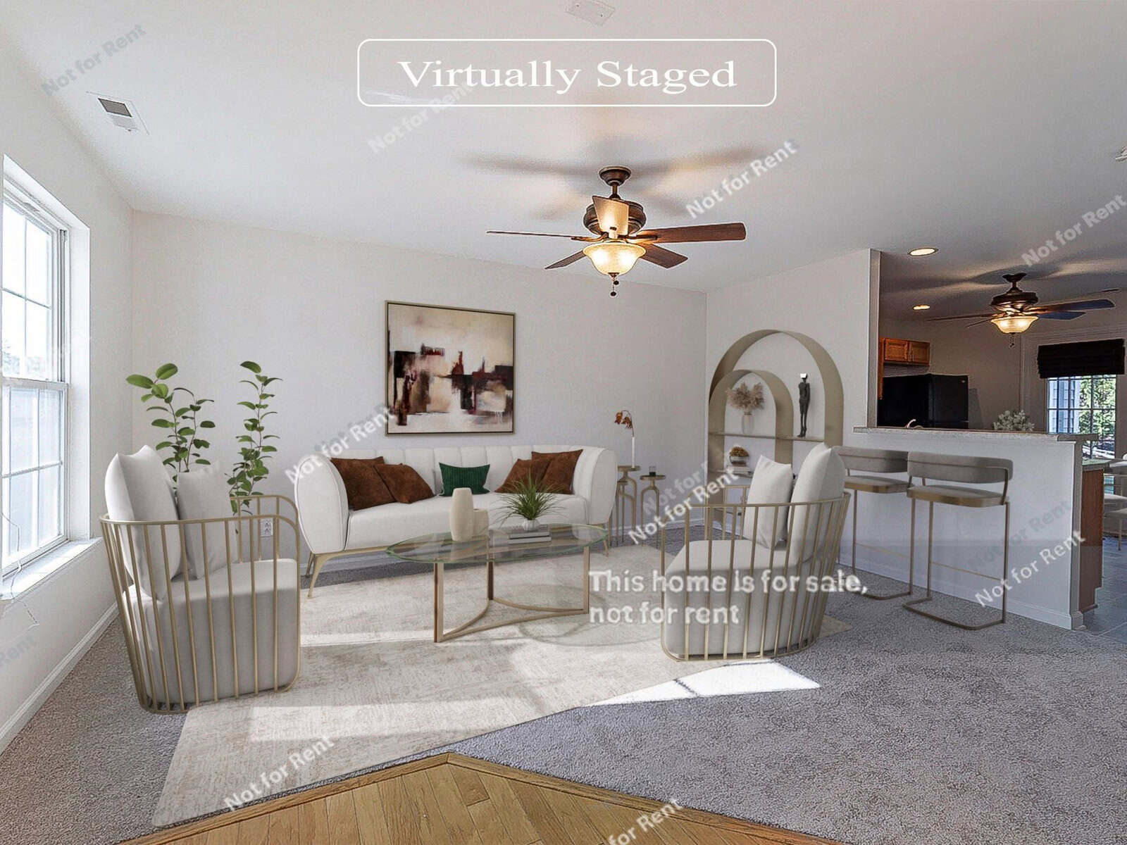 A virtually staged living room with a modern design features white walls, a ceiling fan, and a large window. It includes a white sofa, two metal-frame chairs, a glass coffee table, and abstract art on the wall. Text reads, "This home is for sale, not for rent.